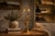 A tall and elegant brass table lamp featuring the iconic hollywood regency palm leaf motif, here presented in a slightly...
