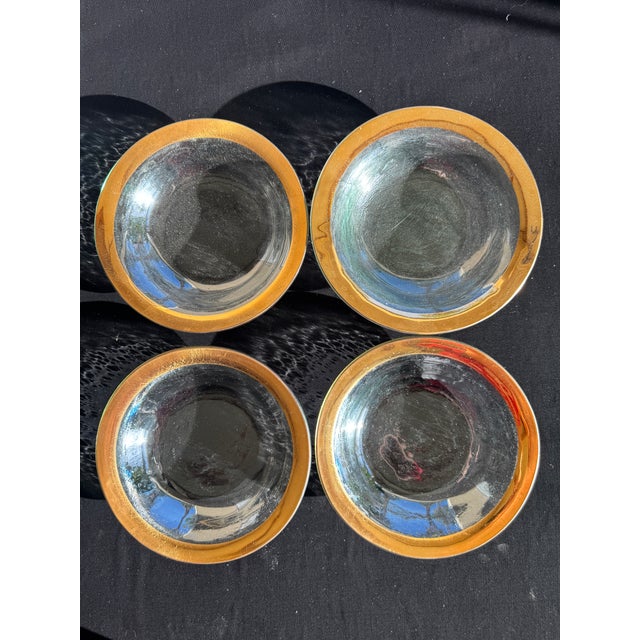 A set of four Annieglass Roman Antique bowls, each hand-formed with a wide, shallow profile and finished with a band of...