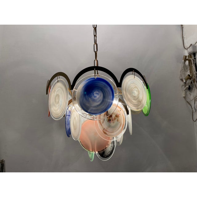 Murano glass disc chandelier 1970’s dull gold colored frame murano glass discs each disc varies in color and size as each...