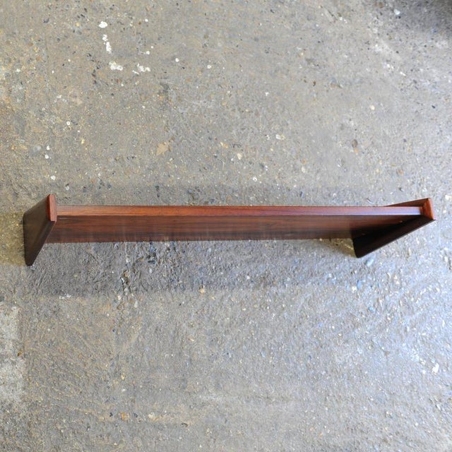 A striking set of four mid-century modern floating wall shelves dating from the 1960s. Crafted in beautifully figured wood...