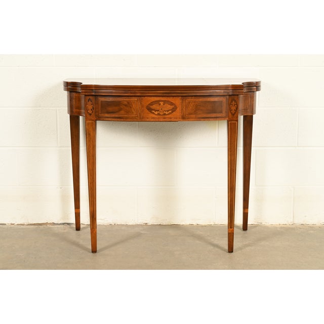 A gorgeous Federal or Hepplewhite style flip-top console or game table By Baker Furniture USA, Circa 1980s Mahogany, with...
