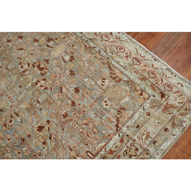 An antique Persian Malayer rug with an all-over design on a gray abrashed ground, accents in rust, caramel, ivory and...