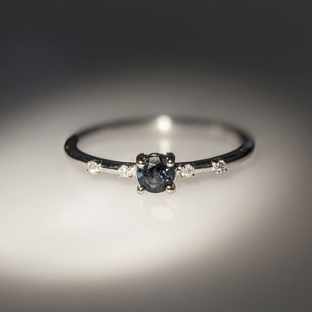 This beautiful ring features an alexandrite in 14k white Gold and four diamond accents. A dainty ring design perfect for...