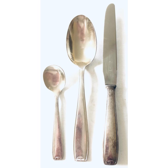 Start a collection or supplement a current one, this heavily silver plated vintage French set of flatware by Guy Degrenne...