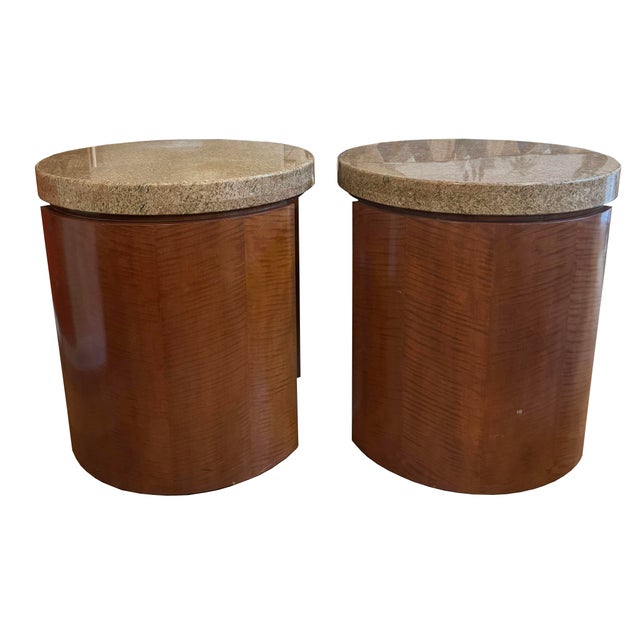 A sleek minimalist pair of round sculptured side tables in a rich mahogany stain with thick polished-granite tops. Sleek...