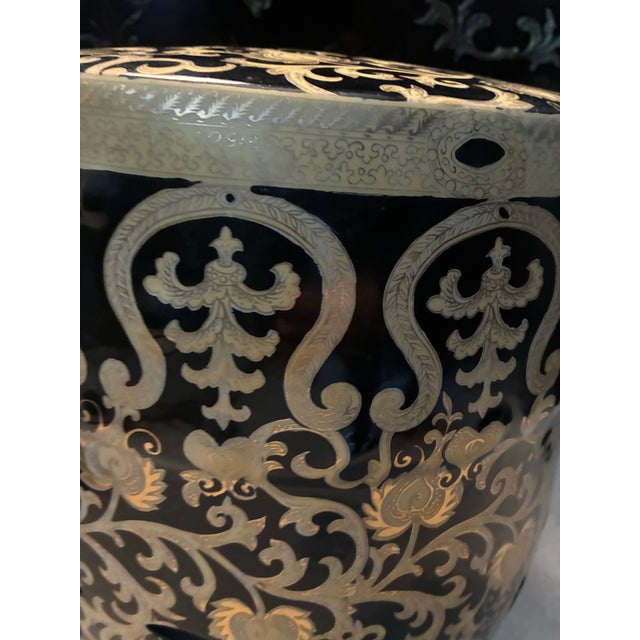 This is a Vintage Late 20th Century large Black and Gold Garden Stool