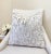 This pillow features a sculptural pattern of ivory and beige velvet shapes over a textured white bouclé background. The...