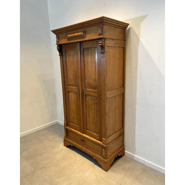 Bring warmth and character into your interior with this beautiful antique solid oak wardrobe cabinet. This impressive...