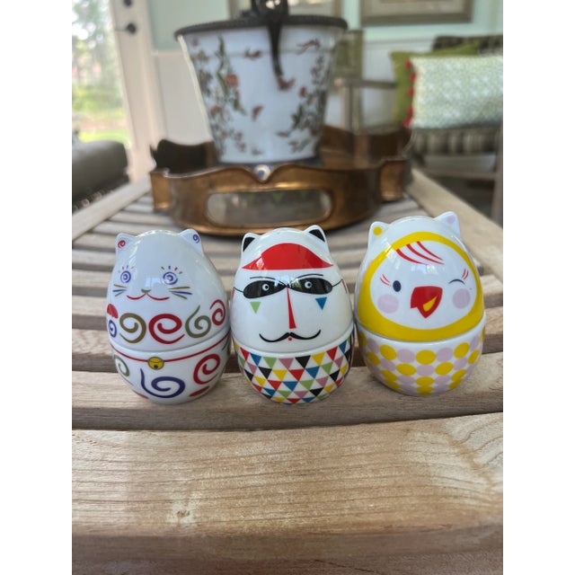 Set of three Ritzenoff egg cups with salt shakers. Egg-shaped creations with a bottom to hold the egg and the top to hold...