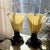 vintage Ting Shen hollow light-up table lamps feature amber-yellow ribbed glass shades paired with ornate, dark metal...