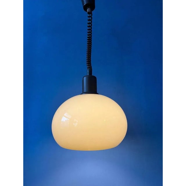 Vintage space age mushroom pendant lamp in beige colour. The acrylic glass shade produces a magnificent glow. The height...