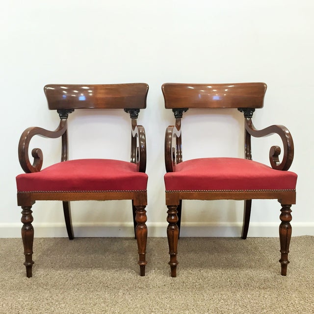 In mahogany and on carved feet with brass castors, the scroll arms with carved anthemion leaves at the top. In very good...