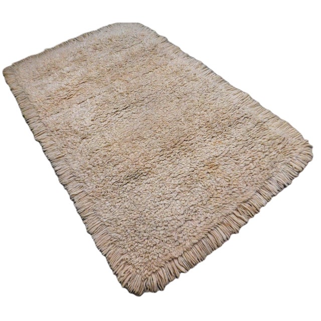 Vintage handmade flokati rug. Lush wool pile in solid beige. Natural undyed wool. 4'x 6'