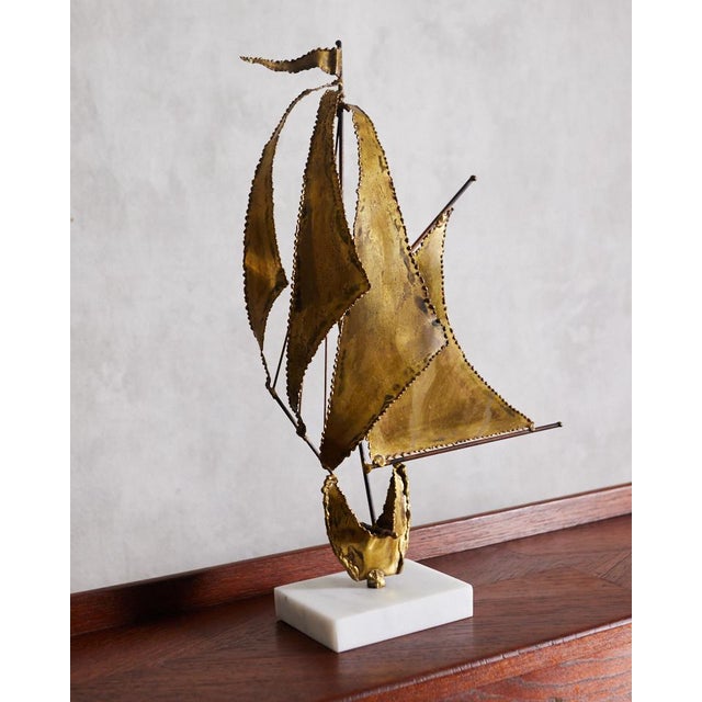 A truly stunning mid century sailboat sculpture. This piece was found with a painted wooden base and replaced with a...