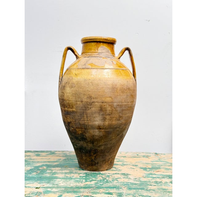 A striking 1800s Spanish terracotta olive jar, sourced from Southern Spain and once used for storing olive oil or wine....