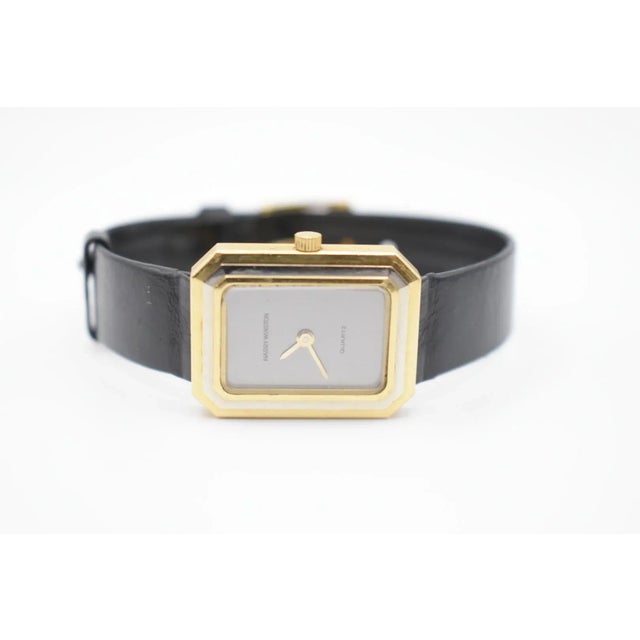 This is a classic Harry Winston watch. It is gold and black leather. The face watch is 18k gold with stepped bezel and...