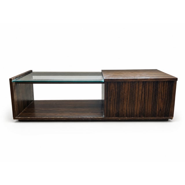 A distinctive vintage Art Deco Revival coffee table featuring a long, low-profile silhouette and an asymmetrical...