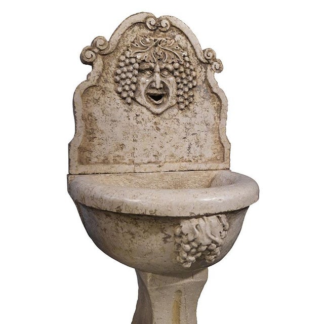 Wall fountain in red Verona marble, composed of three modules: pedestal, basin and front. The pedestal features an elegant...