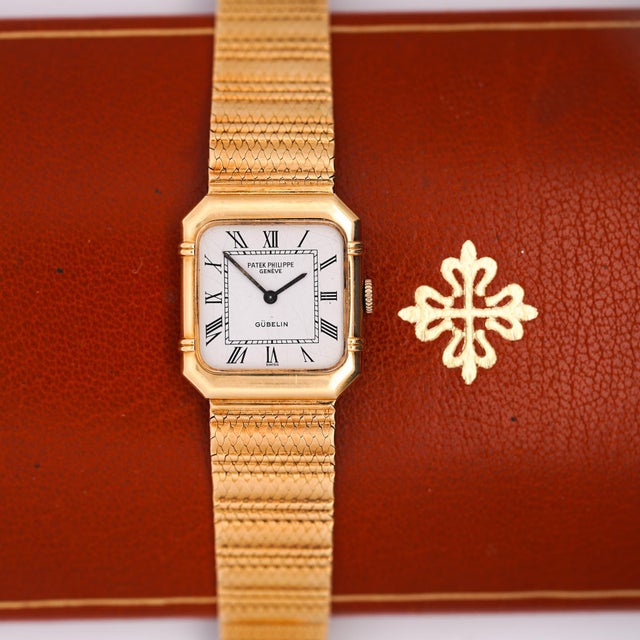 Double signed vintage Patek Philippe for Gübelin ref. 4457/1 manual wind wristwatch in 18K yellow gold, featuring a white...