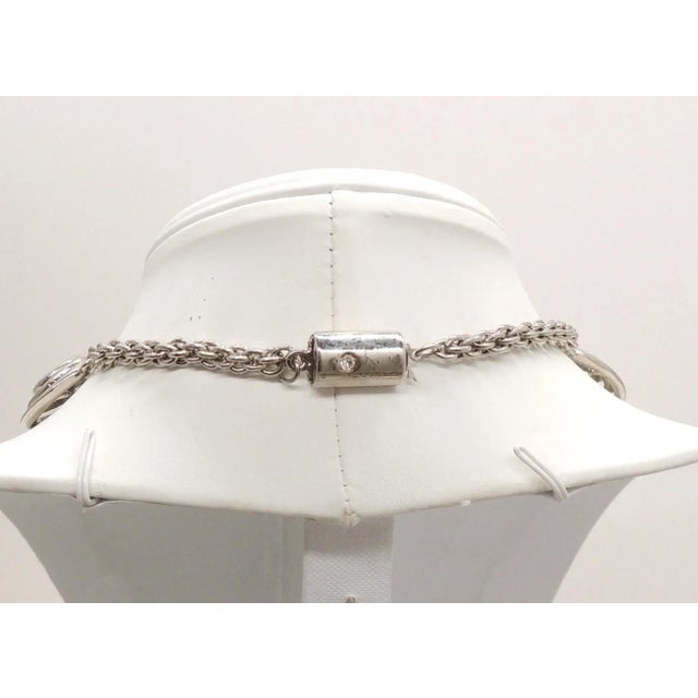 This is part of Chairish’s Costume Jewelry assortment. 1970s Modernist rhodium plated spiral links with cabochon faux-...