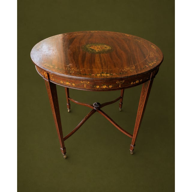 Beautiful antique Edwardian Sheraton Revival mahogany center table dating to approximately 1895–1910. This elegant round...