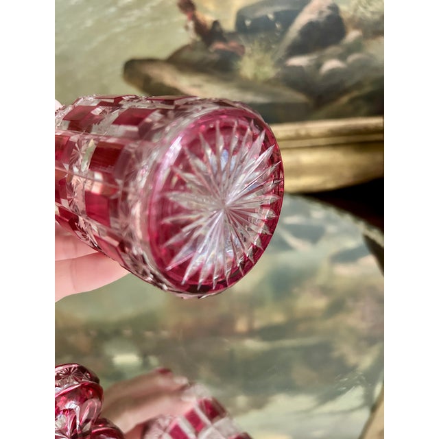 A striking antique Baccarat crystal perfume or toilette bottle in rich cranberry overlay crystal, beautifully cut to clear...
