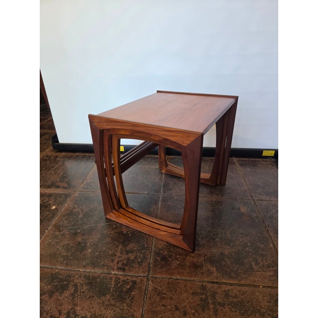 A nice clean and sturdy set of teak Quadrille nesting tables. These are made by E. Gomme G-Plan: designed by Robert Bennett.