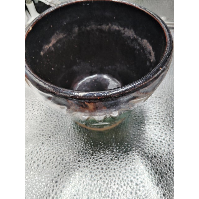 This is a Sun and Moon indoor or outdoor style celestial dip glaze green and brown finish pot. The maker is Robinson...