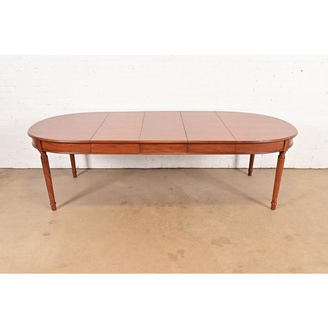 An exceptional French Regency Louis XVI style carved teak extension dining table In the manner of Henredon USA, Circa...