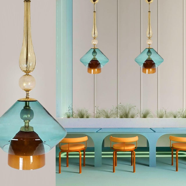 Pair of Murano glass Mid-Century Modern pendant lights, Italy circa 2000s. The Italian chandeliers are made of gold,...