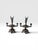 A beautifully detailed pair of antique Victorian silver-plated figural candlesticks featuring winged cherubs standing atop...