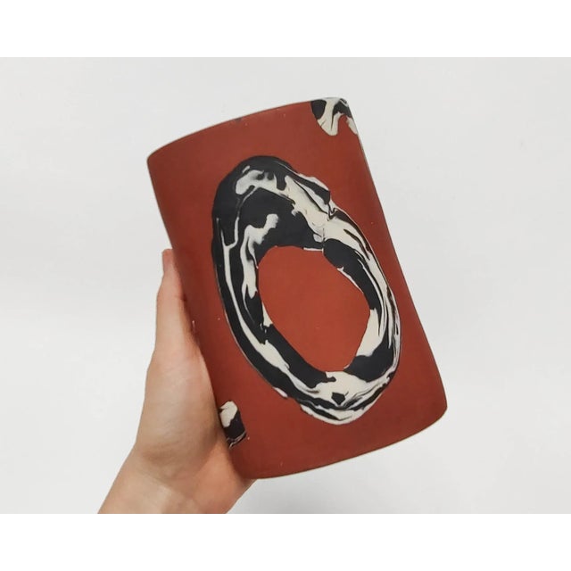 Handmade vase with black and white clay inlayed into red clay. Made and fired in Los Angeles by Fizzy Ceramics in 2024....