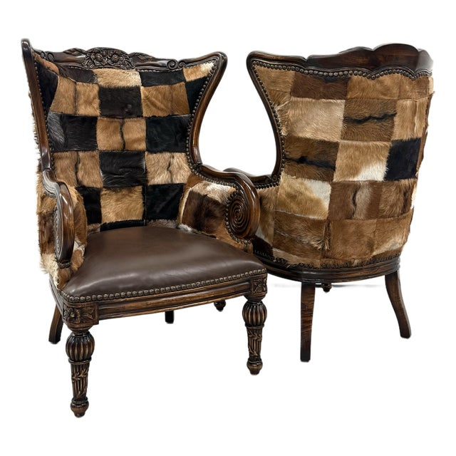 Vintage Carved Wood Patchwork Cowhide Wingback Chairs - Pair For Sale