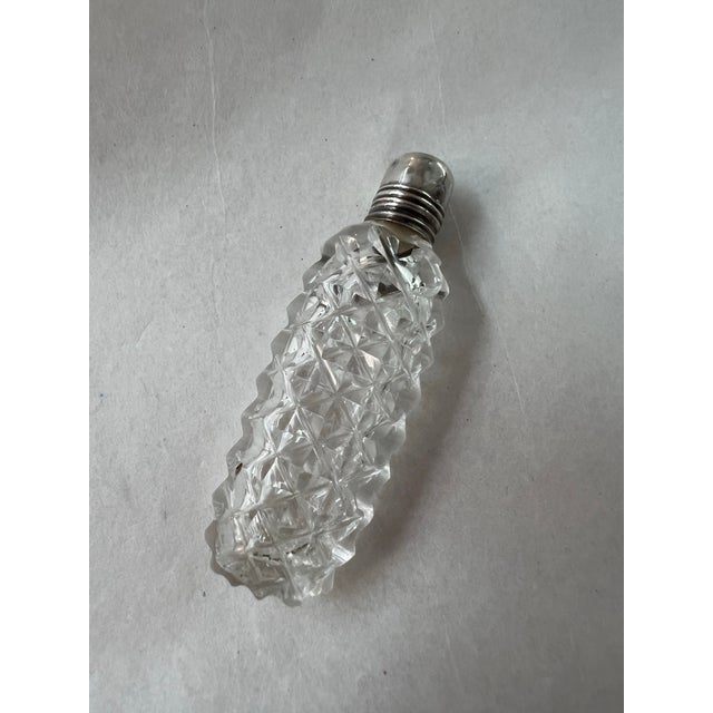 Antique Cut Glass miniature perfume bottle with glass topper and sterling silver cap. Measures 2 1/4 " tall