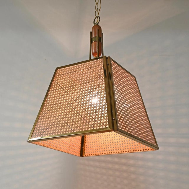 Fantastic pendant in gilt metal, vienna straw, and glass. This incredibly stylish hanging light was designed and produced...