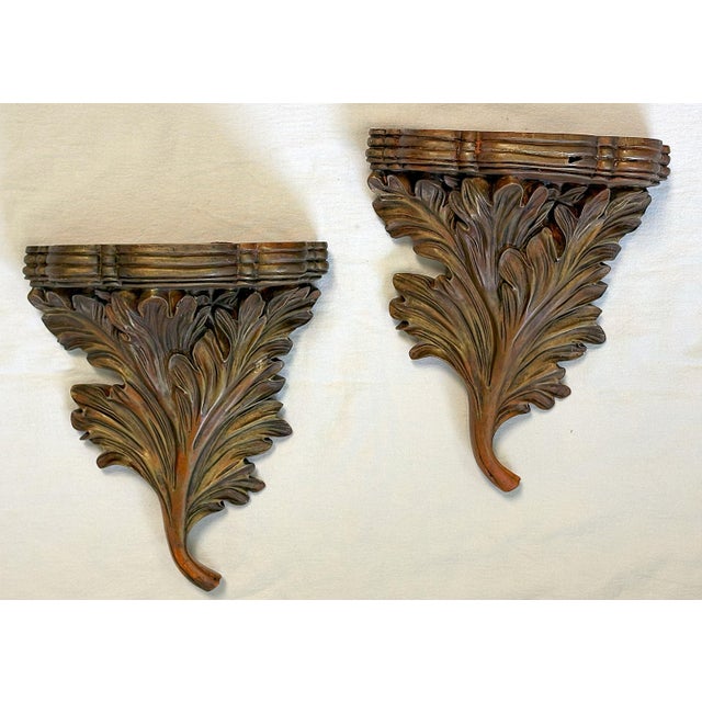 Nice vintage pair of decorative wall brackets. They're made of a molded synthetic material with an acanthus leaf design...