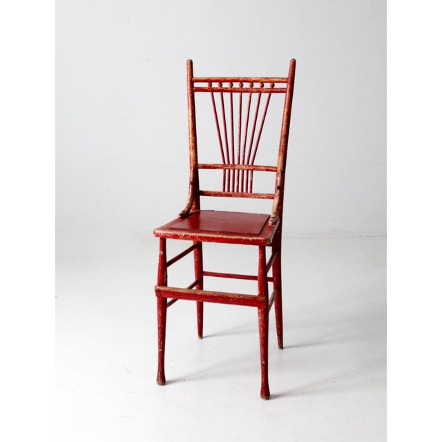 This rare antique spindle back chair makes a bold statement with its vibrant tomato red paint and beautifully aged patina....