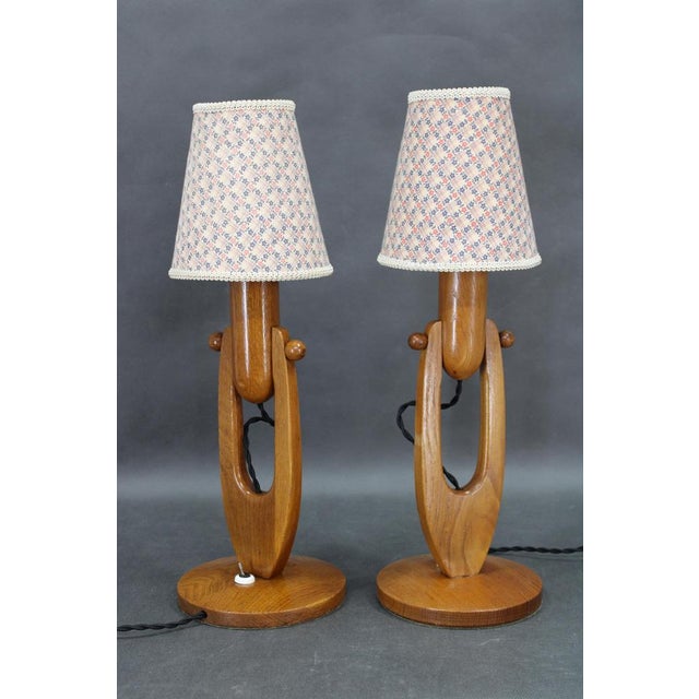 This elegant pair of adjustable wooden table lamps was produced in czechoslovakia in the 1970s and represents a refined...