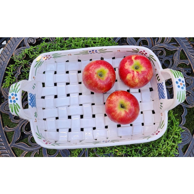 A vintage hand-painted floral ceramic basket. Handcrafted with thick strips of cut ceramic, woven in a basket weave...