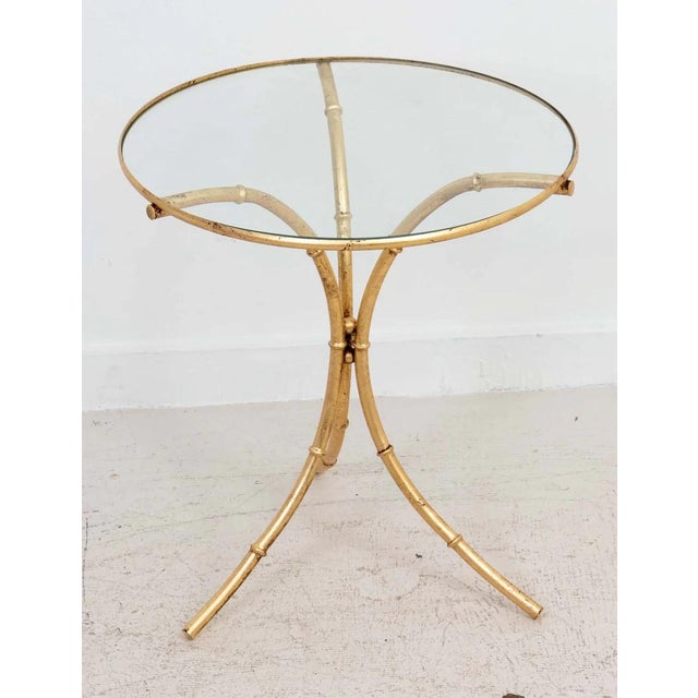 Italian Gilt metal Faux Bamboo side table with inset glass top. Naturally distressed gilt finish from age and use for a...
