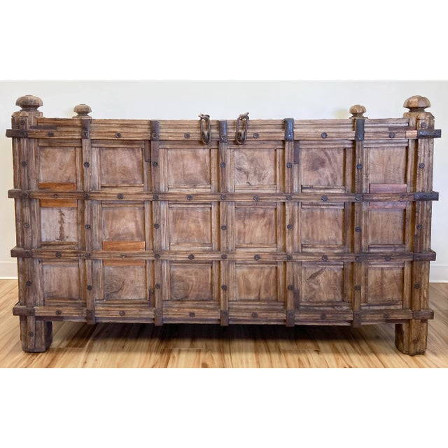 Monumental antique Anglo-Indian Damchiya, or dowry chest. Stunning carved Burmese teak with hand forged iron strap work,...
