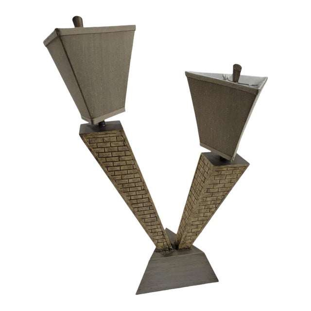 This table lamp captures the bold lines and architectural drama reminiscent of classic skyscrapers. The stepped body and...