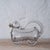 A vintage figural decanter crafted in clear hand-blown glass, designed as a playful dog with a cork stopper at the mouth...
