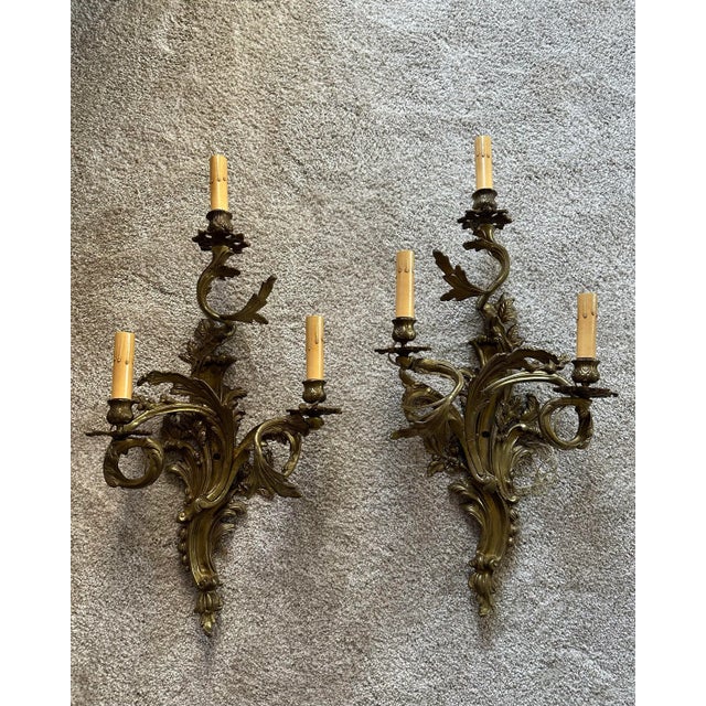 Exquisite pair of French bronze electrified wall sconces measuring 26” h x 12.5” w x 6.5”d Electrified and ready to hang....