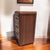 An American Art Deco waterfall nightstand dating to the 1930s, with a warm wood finish, curved waterfall-edge profile, and...