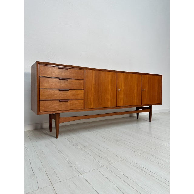 Beautiful and spacious vintage Mid-Century teak sideboard, an original piece from the 1960s. This timeless design embodies...
