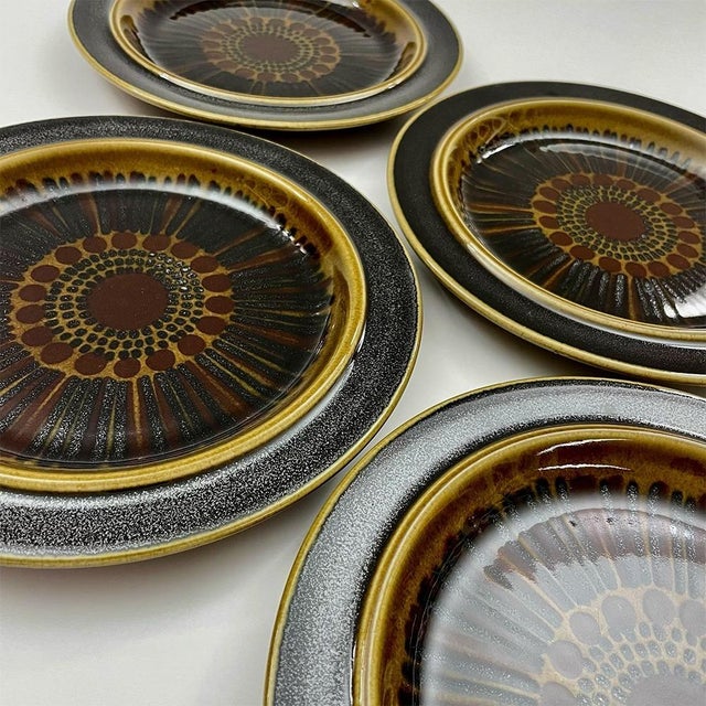 Set of four ceramic dessert plates from the Finnish manufacturer Arabia by Gunvor Olin-Grönqvist. Kosmos pattern, hand-...