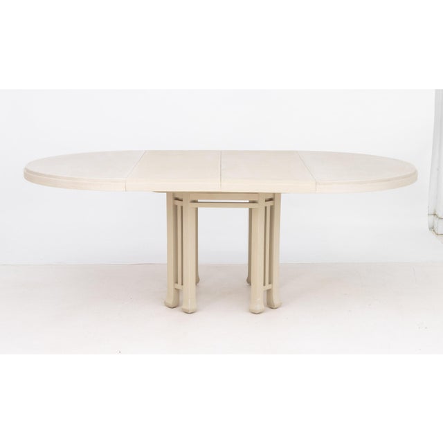 Karl Springer Style Beige Grasscloth Dining Table, with two leaves, pedestal base. Closed: 30" H x 48" W x 47.5" D; open:...