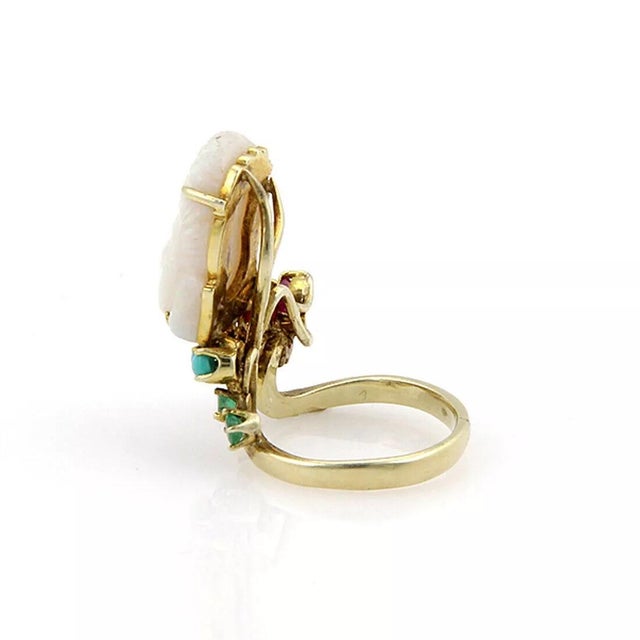 This is a well carved Buddha opal ring, crafted from 14k yellow gold with a polished finish. The carved Buddha's head is...