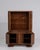 A striking Art Deco display cabinet characterized by geometric lines and balanced proportions. The glazed sections provide...